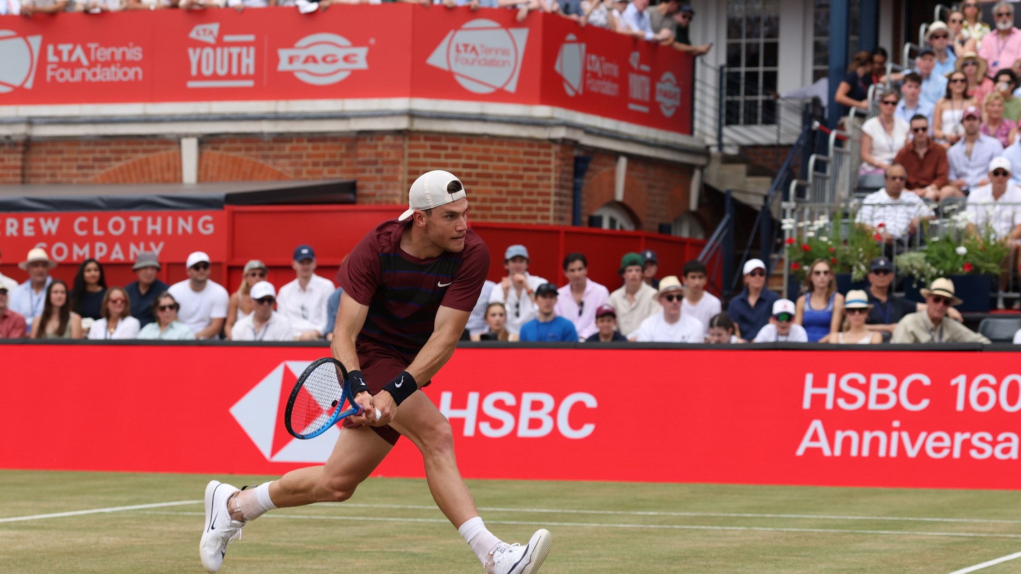 Jack running to hit a back hand on the grass courts at The Queen's Club