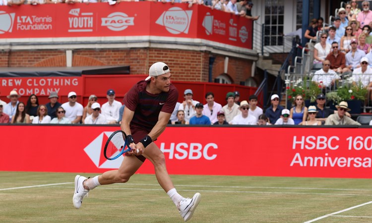 Jack running to hit a back hand on the grass courts at The Queen's Club