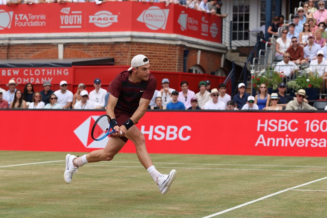 Jack running to hit a back hand on the grass courts at The Queen's Club
