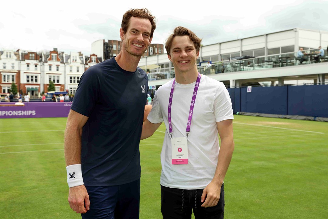 Andy Murray stood on a practice court at the cinch Championships alongside McLaren Racing driver Oscar Piastri