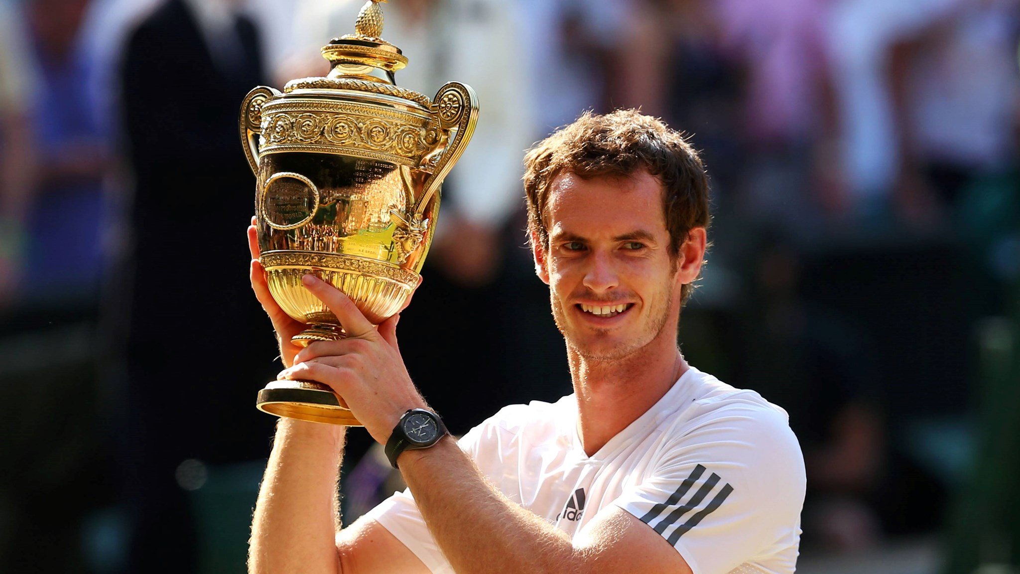 Andy Murray holding his first Wimbledon title in 2013