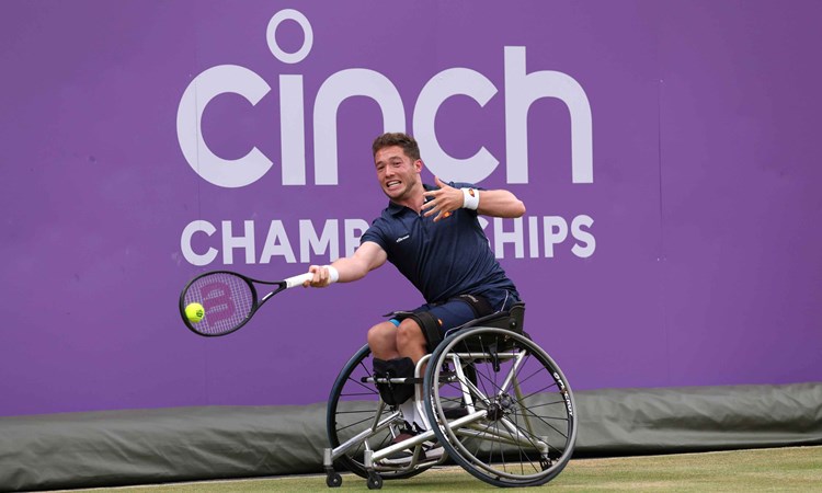 Wheelchair tennis player Alfie Hewett stretches to hit a forehand on court at the cinch Championships