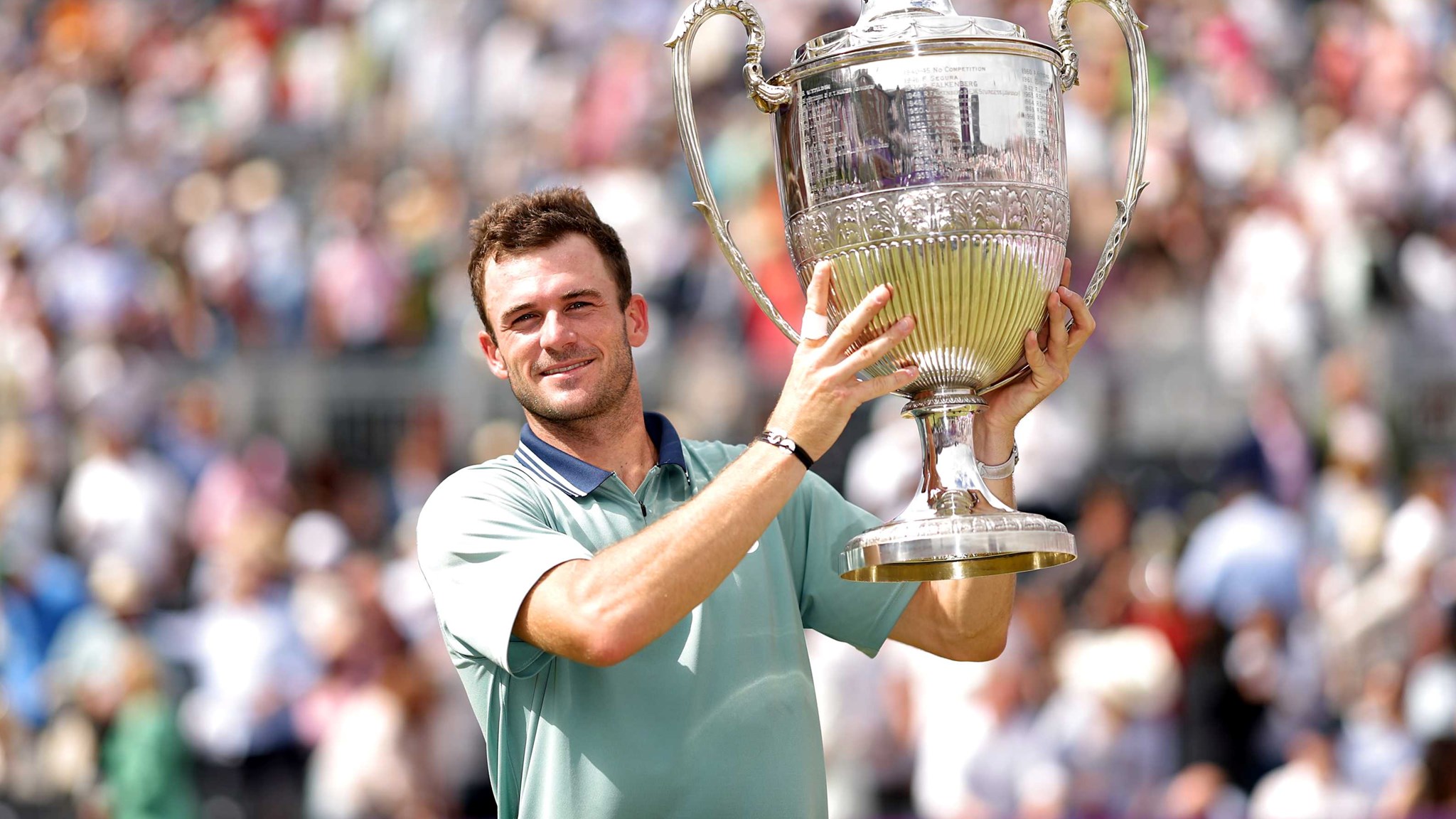 Tommy Paul smiling while lifting the trophy at the cinch Championships