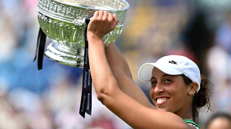 Madison Keys lifting the Eastbourne trophy above her head on court in celebration