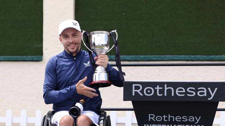 Wheelchair player Andy Lapthorne holding his trophy on court at the Rothesay International Eastbourne