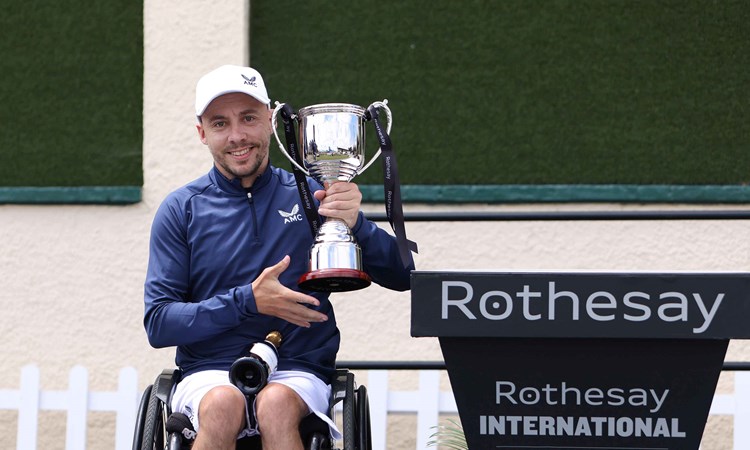 Wheelchair player Andy Lapthorne holding his trophy on court at the Rothesay International Eastbourne