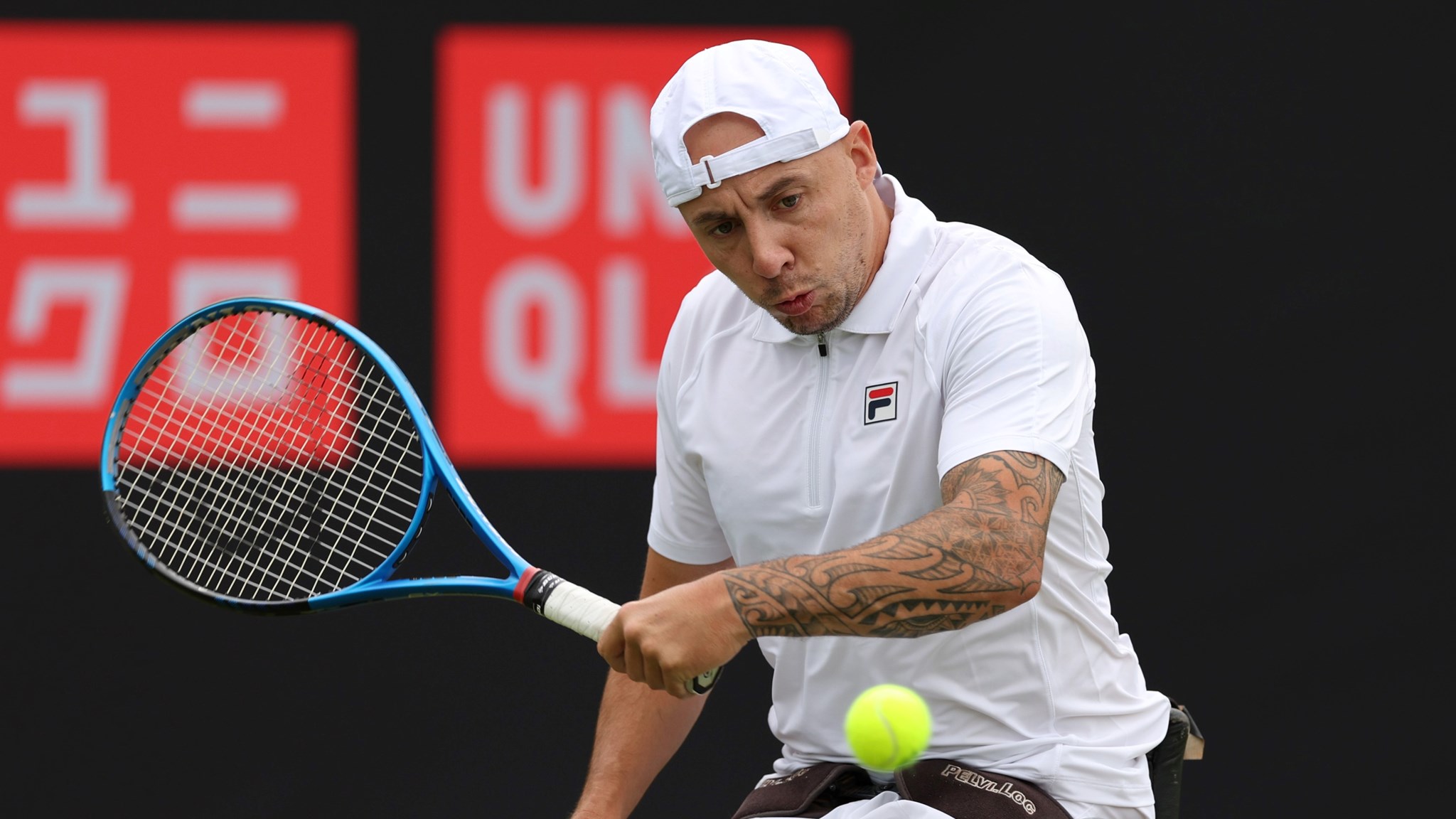 Andy Lapthorne of Great Britain plays a backhand against Heath Davidson of Australia in the Men's Wheelchair Singles match during the Lexus British Open Roehampton at Wimbledon Qualifying and Community Sports Centre on July 02, 2024 in London, England.