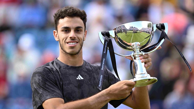 Francisco Cerundolo holding the championship trophy on court at the Rothesay International Eastbourne