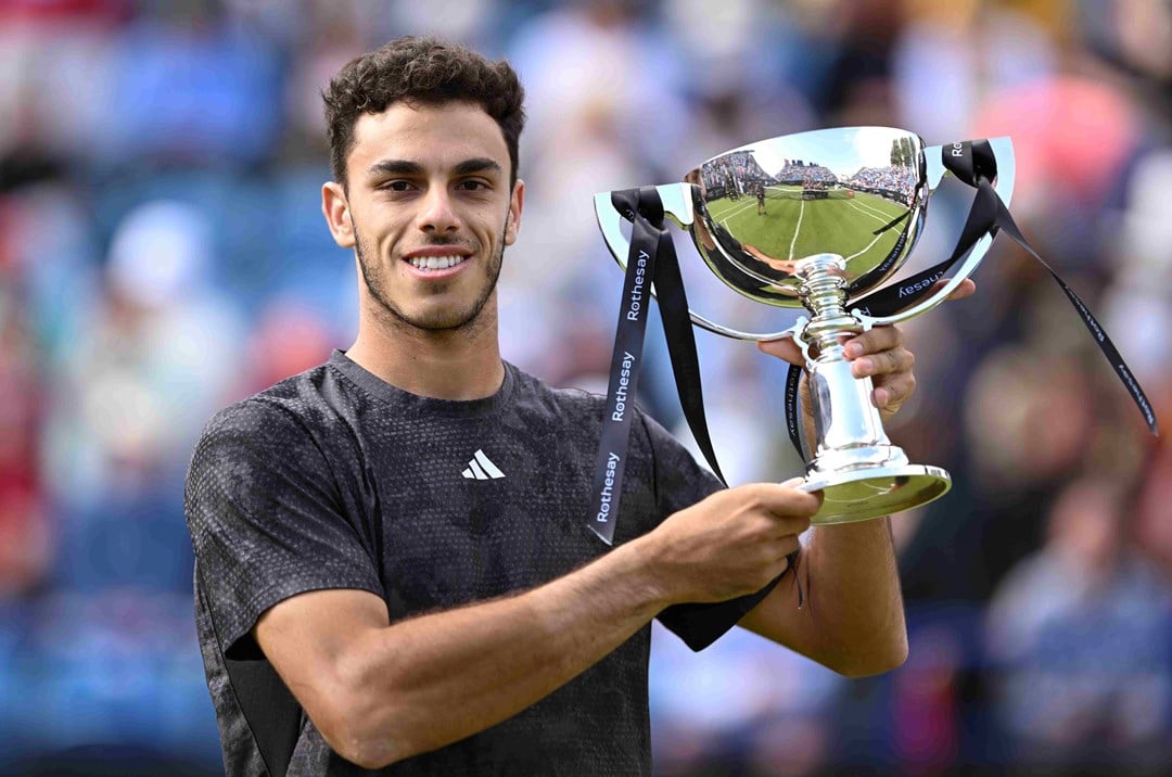 Francisco Cerundolo holding the championship trophy on court at the Rothesay International Eastbourne