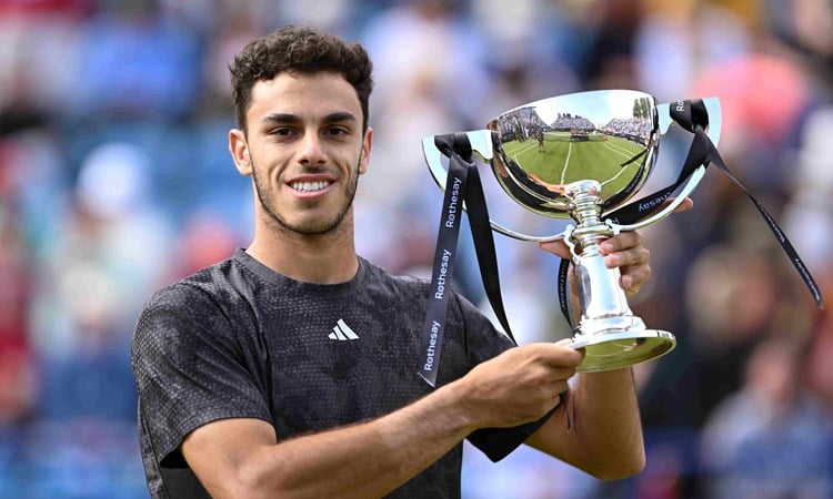 Francisco Cerundolo holding the championship trophy on court at the Rothesay International Eastbourne
