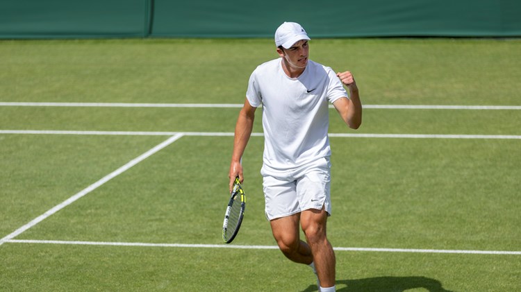 Oliver Tarvet celebrates on the grass court after his Wimebldon qualifying win