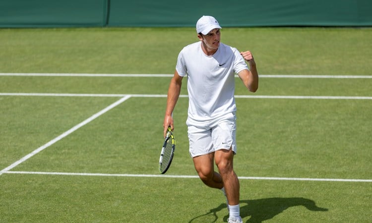 Oliver Tarvet celebrates on the grass court after his Wimebldon qualifying win