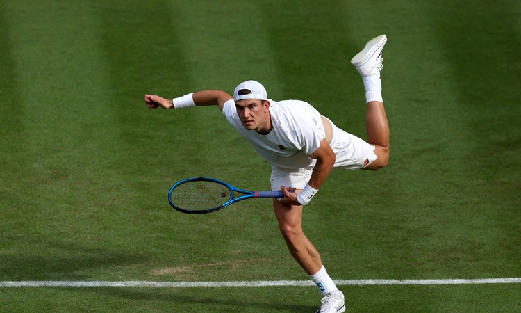 Jack Draper serving in the opening round of Wimbledon 2025