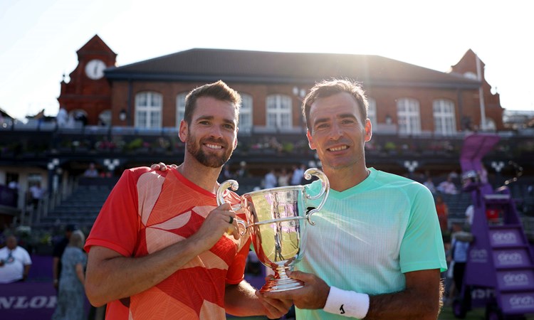 Ivan Dodig and Austin Krajicek holding their championship trophy on court at the cinch Championships