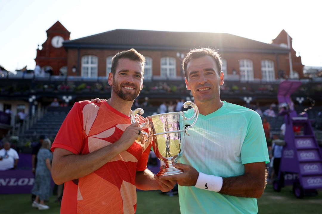 Ivan Dodig and Austin Krajicek holding their championship trophy on court at the cinch Championships
