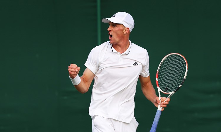 Jan Choinski celebrating match point after winning his opening round at The Championships Wimbledon 2023