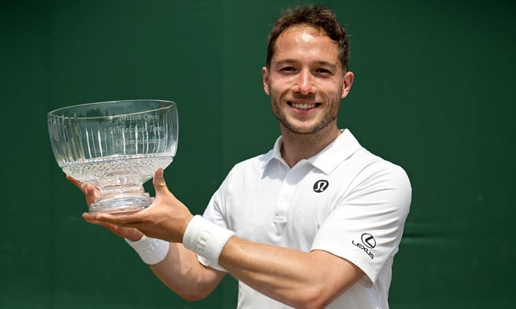 Alfie Hewett smiles while lifting the Lexus British Open trophy