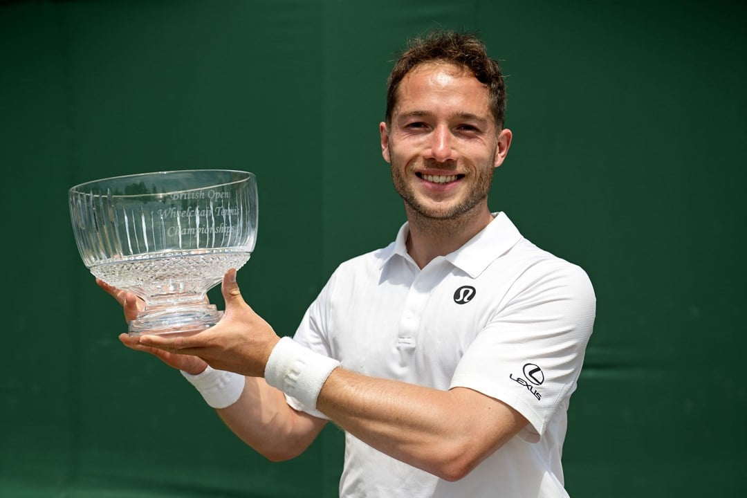 Alfie Hewett smiles while lifting the Lexus British Open trophy