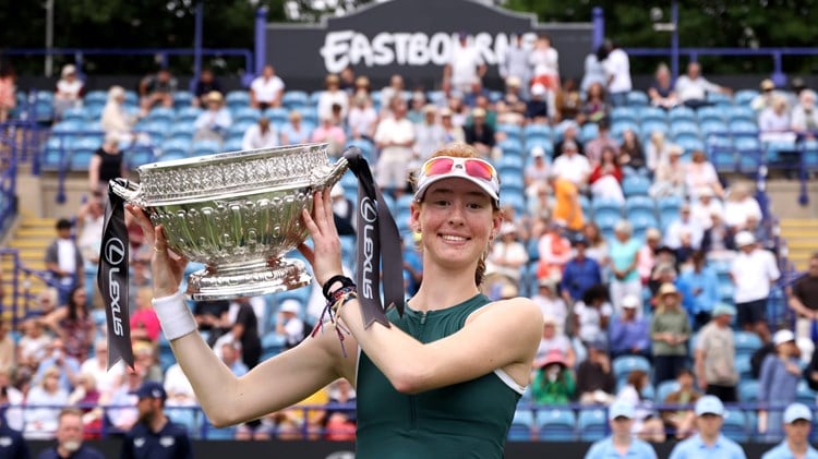 Maya Joint holding the championships trophy and smiling on court at the Lexus Eastbourne Open