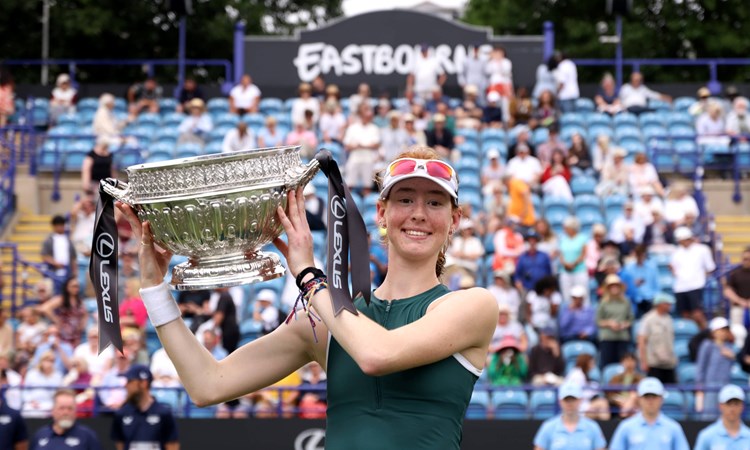 Maya Joint holding the championships trophy and smiling on court at the Lexus Eastbourne Open