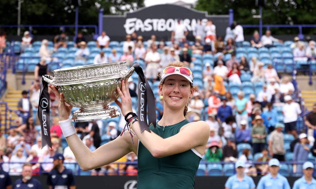 Maya Joint holding the championships trophy and smiling on court at the Lexus Eastbourne Open