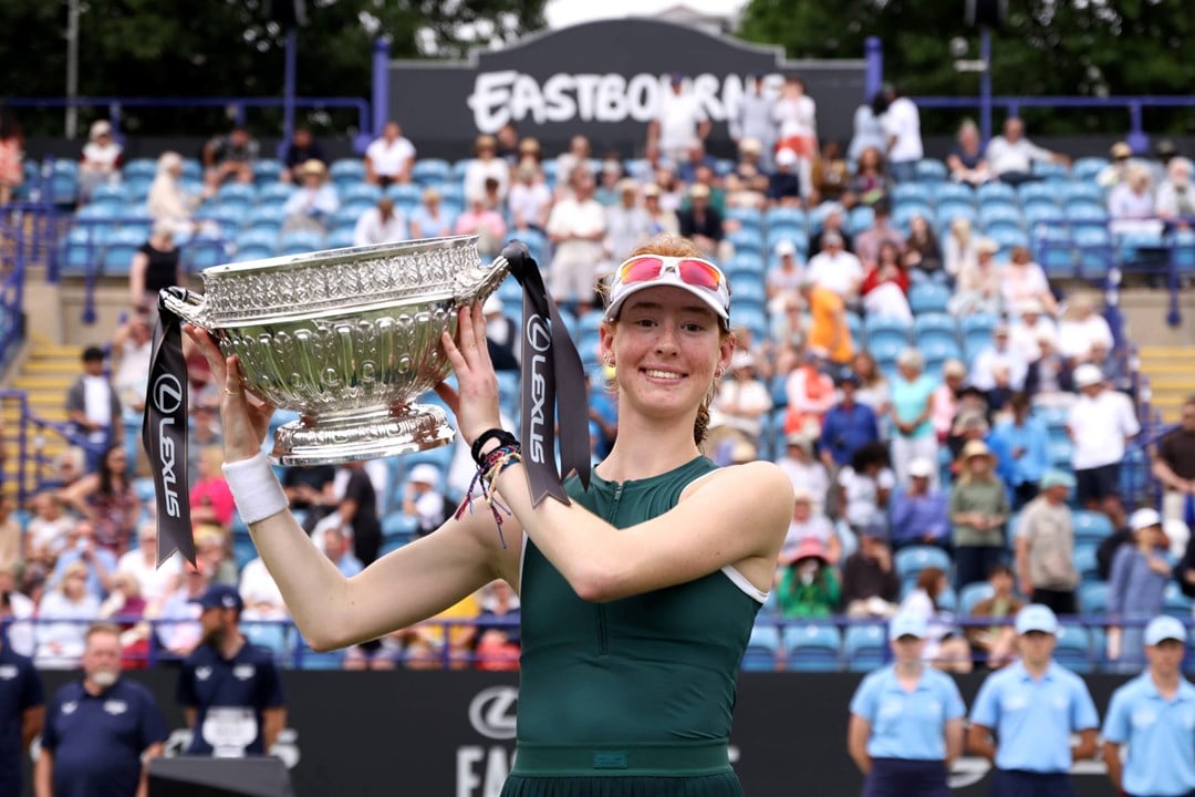 Maya Joint holding the championships trophy and smiling on court at the Lexus Eastbourne Open