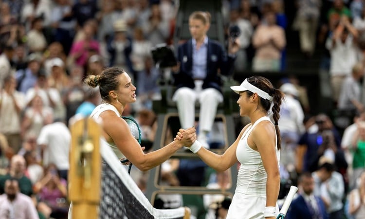 Emma Raducanu shakes hands with Aryna Sabalenka over the net after their third round match at Wimbledon