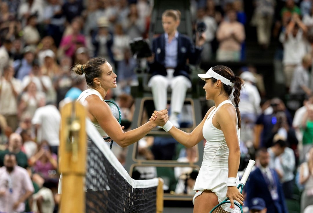 Emma Raducanu shakes hands with Aryna Sabalenka over the net after their third round match at Wimbledon