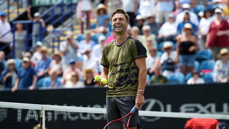 Liam Broady laughs on court after his first round win at the Rothesay International Eastbourne