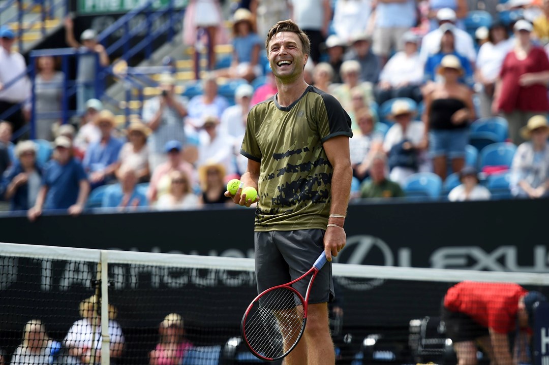 Liam Broady laughs on court after his first round win at the Rothesay International Eastbourne