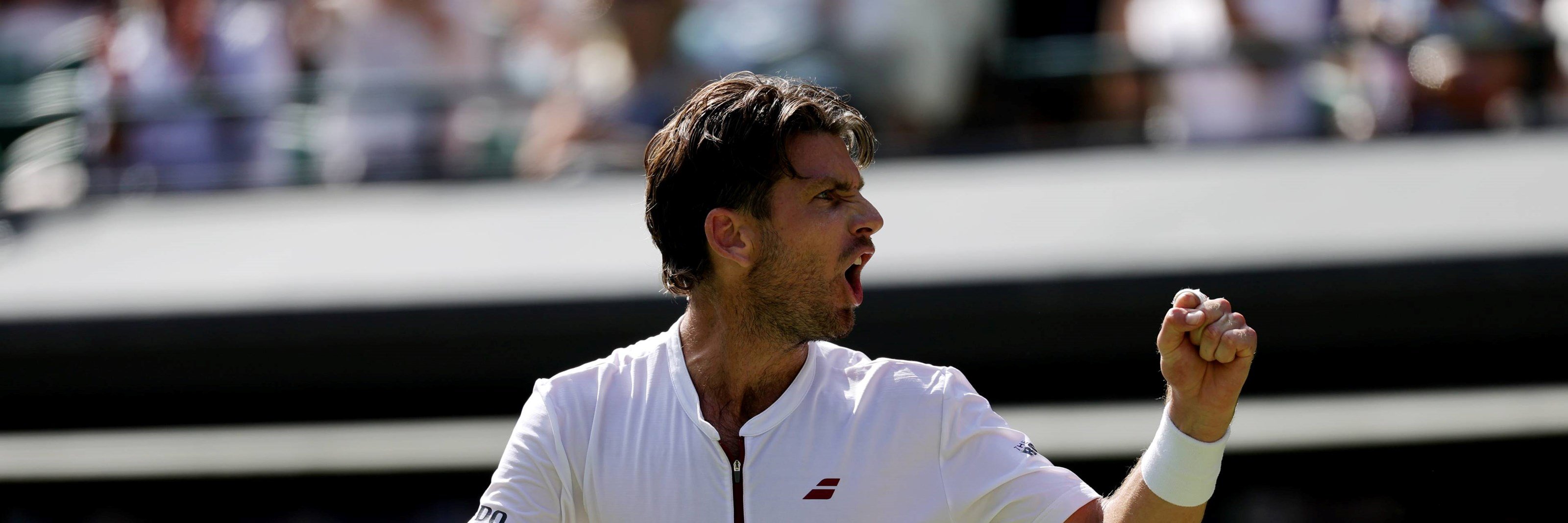 Cam Norrie pumping his fist in celebration at Wimbledon