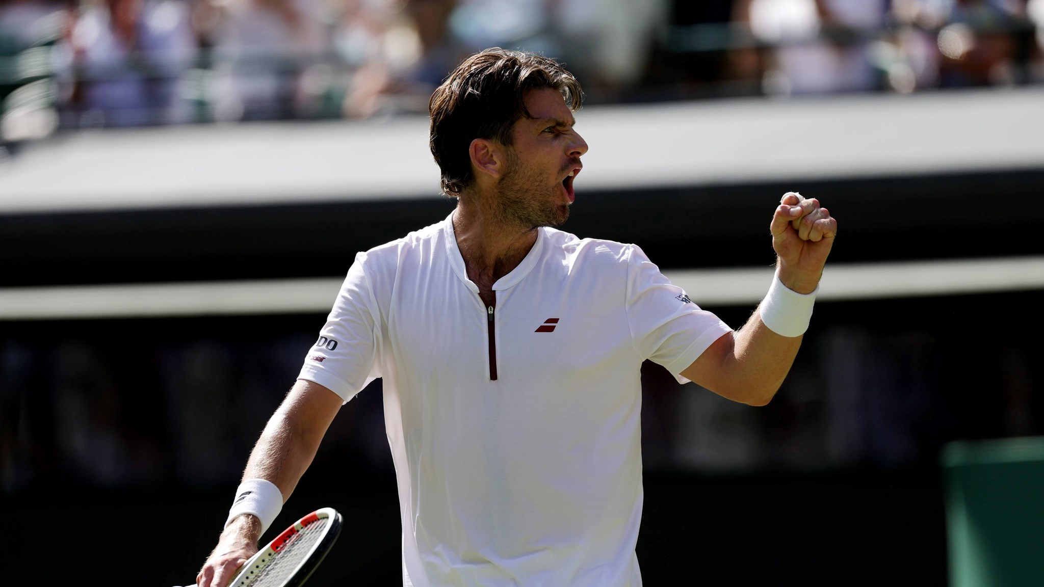 Cam Norrie pumping his fist in celebration at Wimbledon