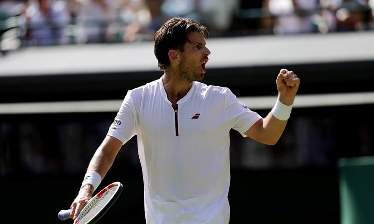 Cam Norrie pumping his fist in celebration at Wimbledon
