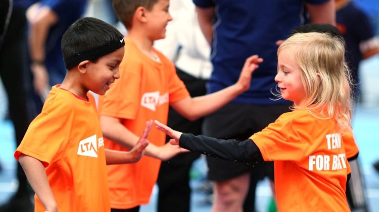 SERVES kids high fiving on court