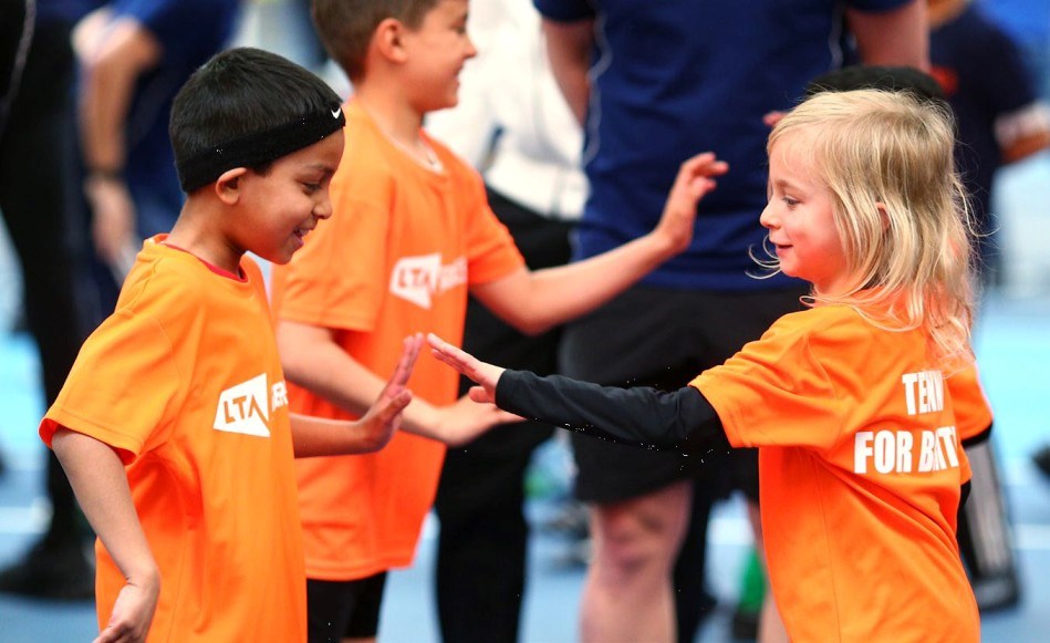 SERVES kids high fiving on court