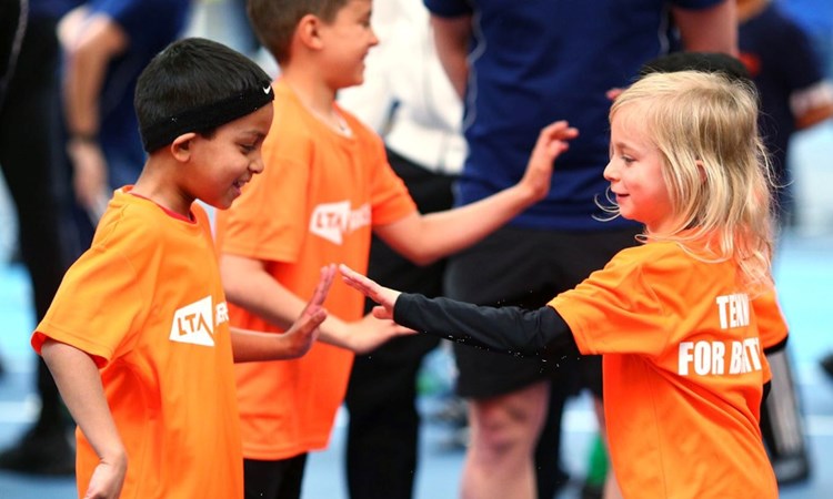 SERVES kids high fiving on court