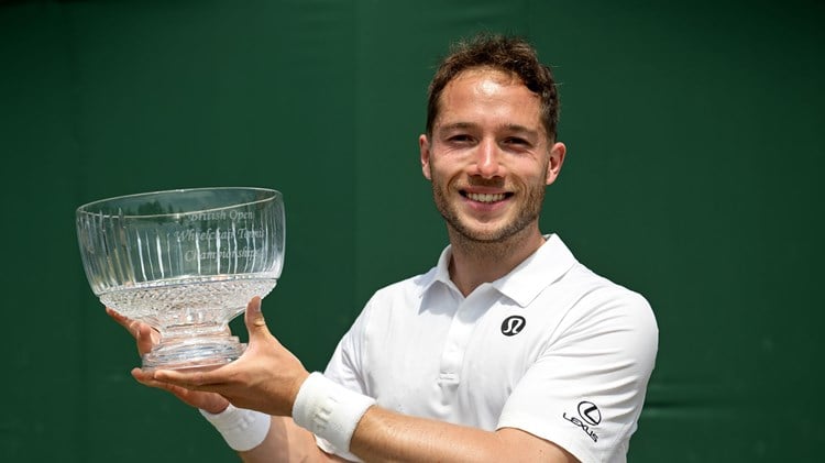 Alfie Hewett smiles while lifting the Lexus British Open trophy