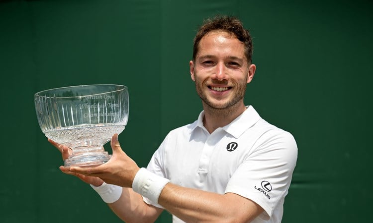 Alfie Hewett smiles while lifting the Lexus British Open trophy