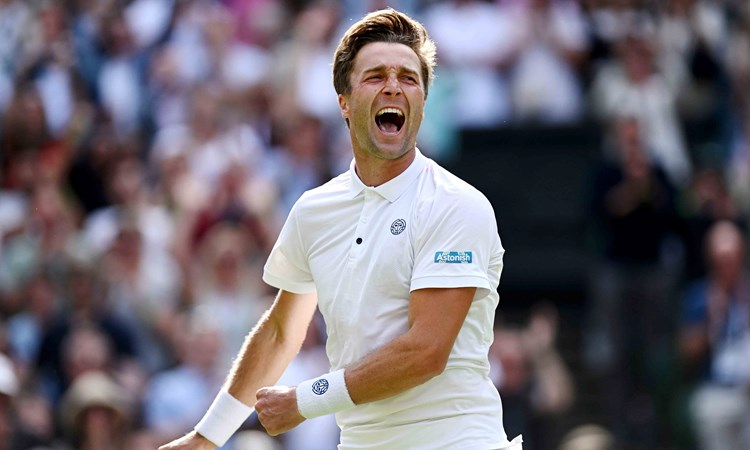 Liam Broady roars in celebration after securing a win against Casper Ruud on centre court at Wimbledon