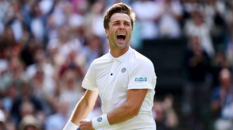 Liam Broady roars in celebration after securing a win against Casper Ruud on centre court at Wimbledon
