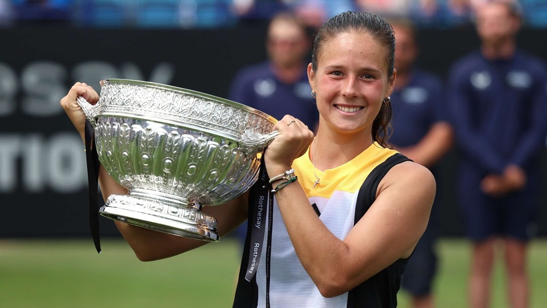 Daria Kasatkina smiling while holding her trophy on court in Eastbourne