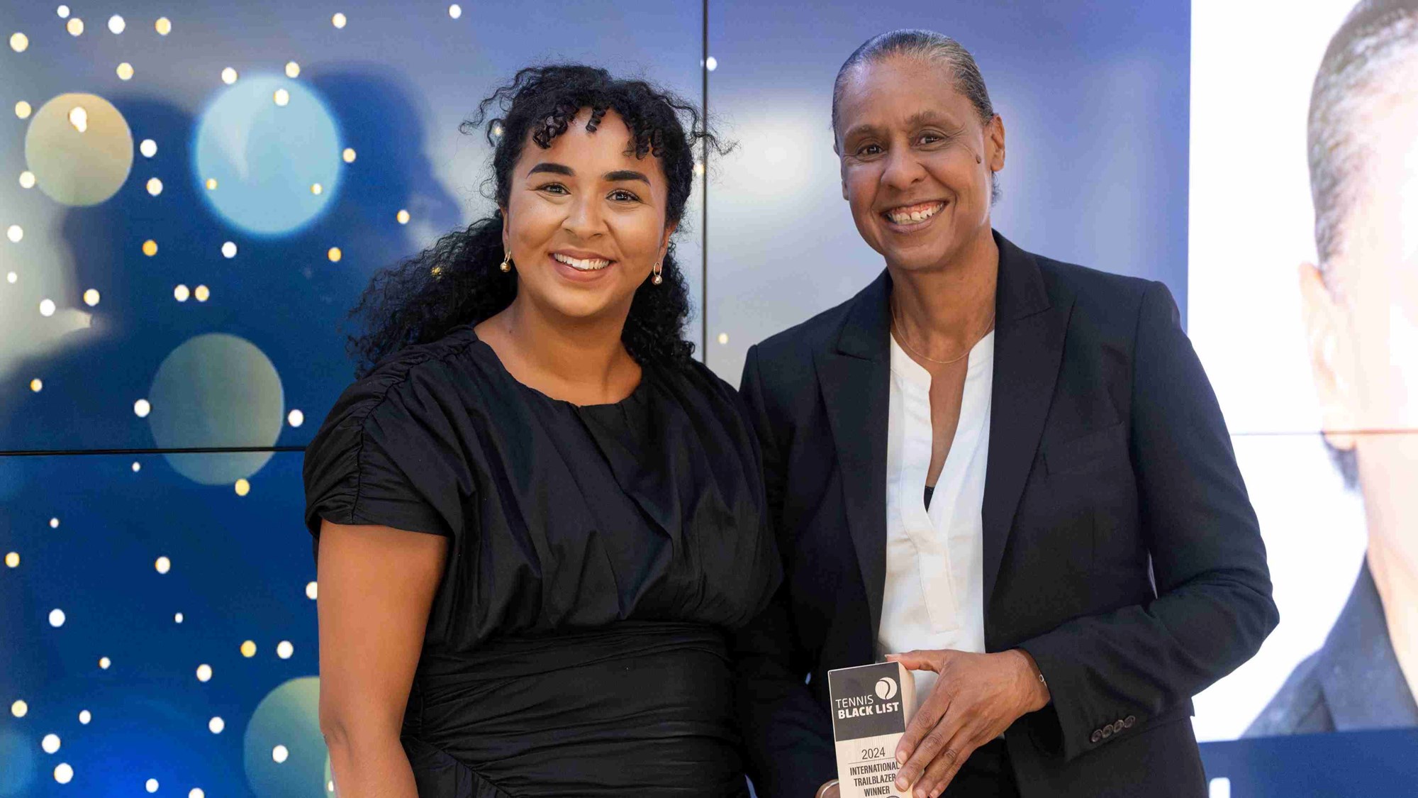 Two of the International Trailblazer Winners at the Tennis Black List smiling while holding their awards