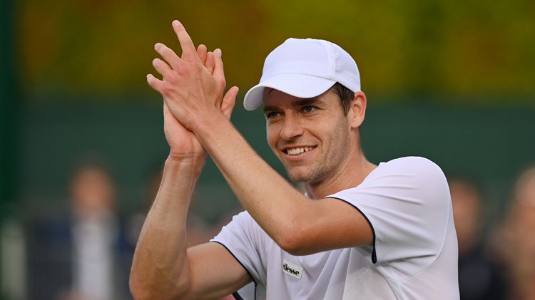 Alastair Gray applauds the crowd after winning on his Wimbledon debut