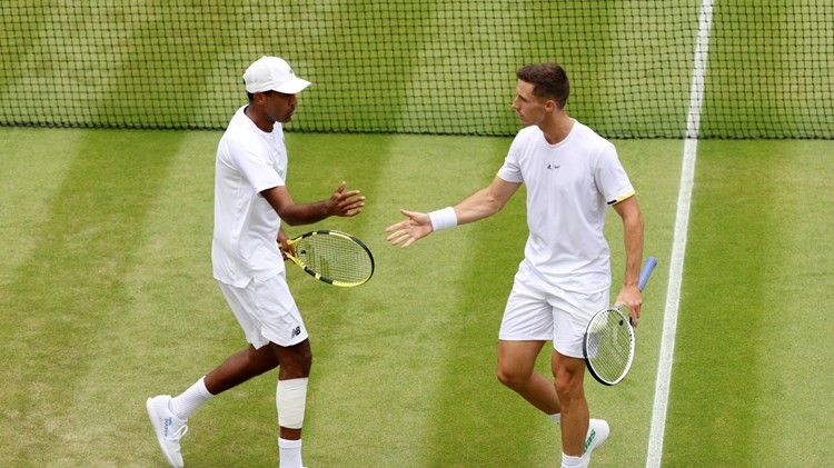 Joe Salisbury and Rajeev Ram high five in the Wimbledon quarter-finals