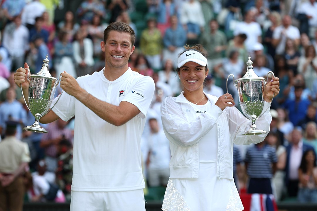 Neal Skupski and Desirae Krawczyk hold up their Trophies after winning the Mixed Doubles Final against Matthew Ebden and Samantha Stosur during the Mixed Doubles Final Match on day eleven of The Championships Wimbledon 2022