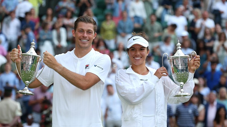 Neal Skupski and Desirae Krawczyk hold up their Trophies after winning the Mixed Doubles Final against Matthew Ebden and Samantha Stosur during the Mixed Doubles Final Match on day eleven of The Championships Wimbledon 2022