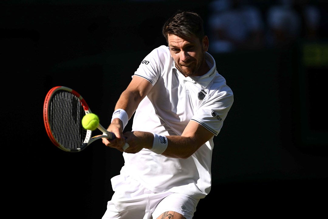 Cam Norrie hitting a backhand on court during his second round match at Wimbledon