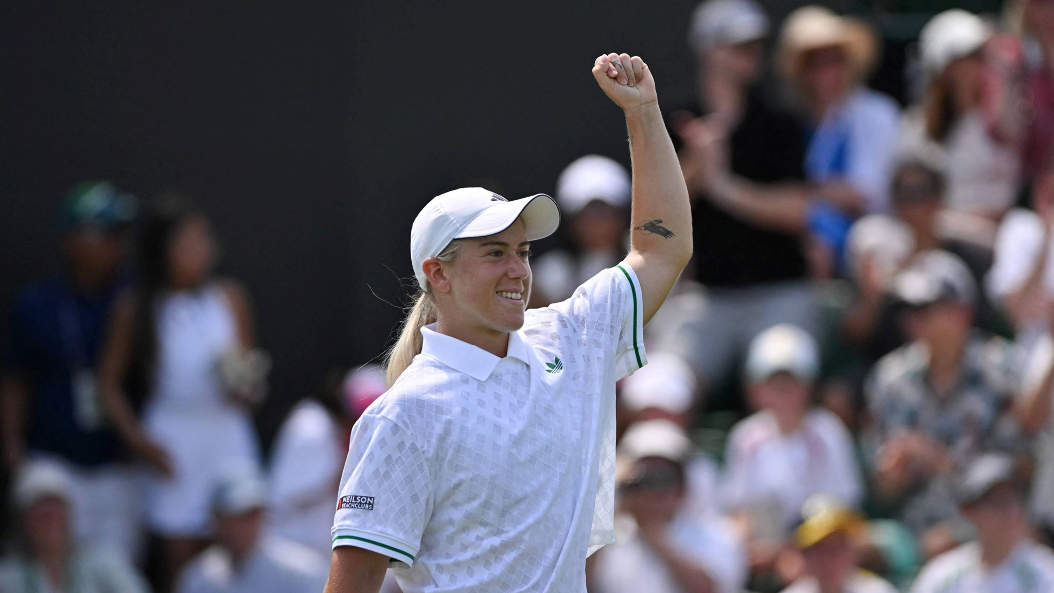 Sonay Kartal pumps her fist in celebration after beating Jelena Ostapenko at Wimbledon