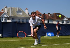 Freddy Blyades bends down to hit a forehand