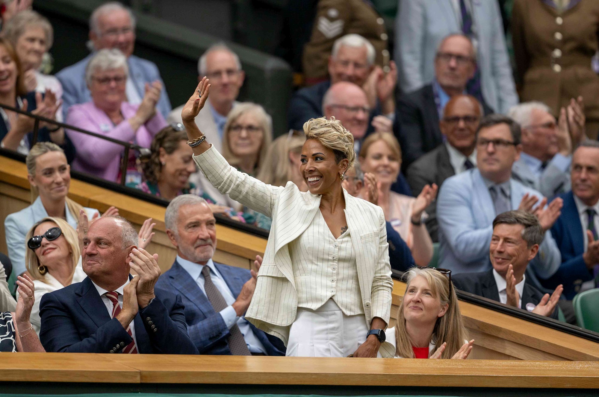 Dame Kelly Holmes stands to address the applauding crowd on Wimbledon's Centre Court